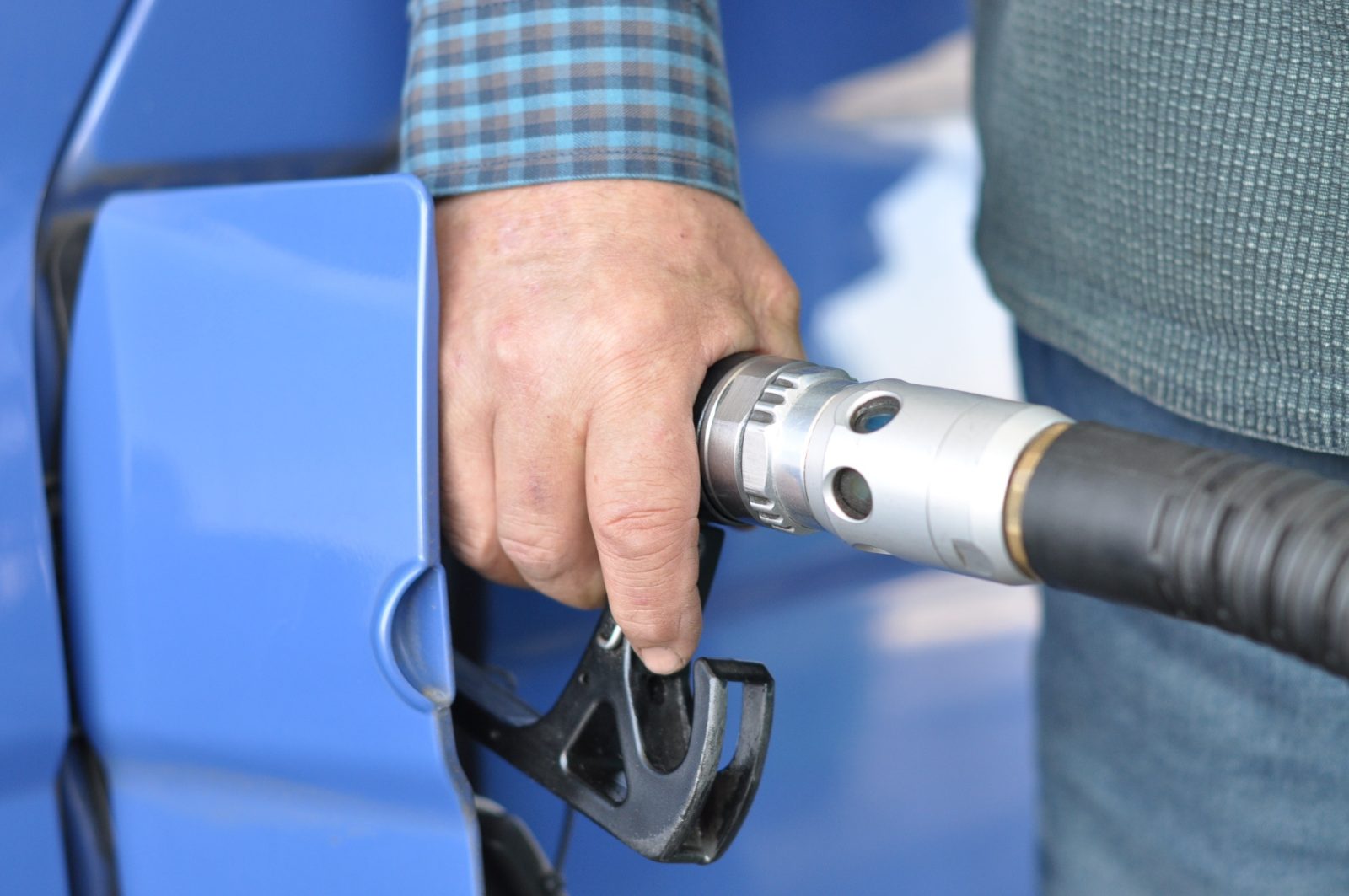 Diesel fuel nozzle refueling a heavy-duty truck, illustrating the impact of fuel prices on transportation costs.